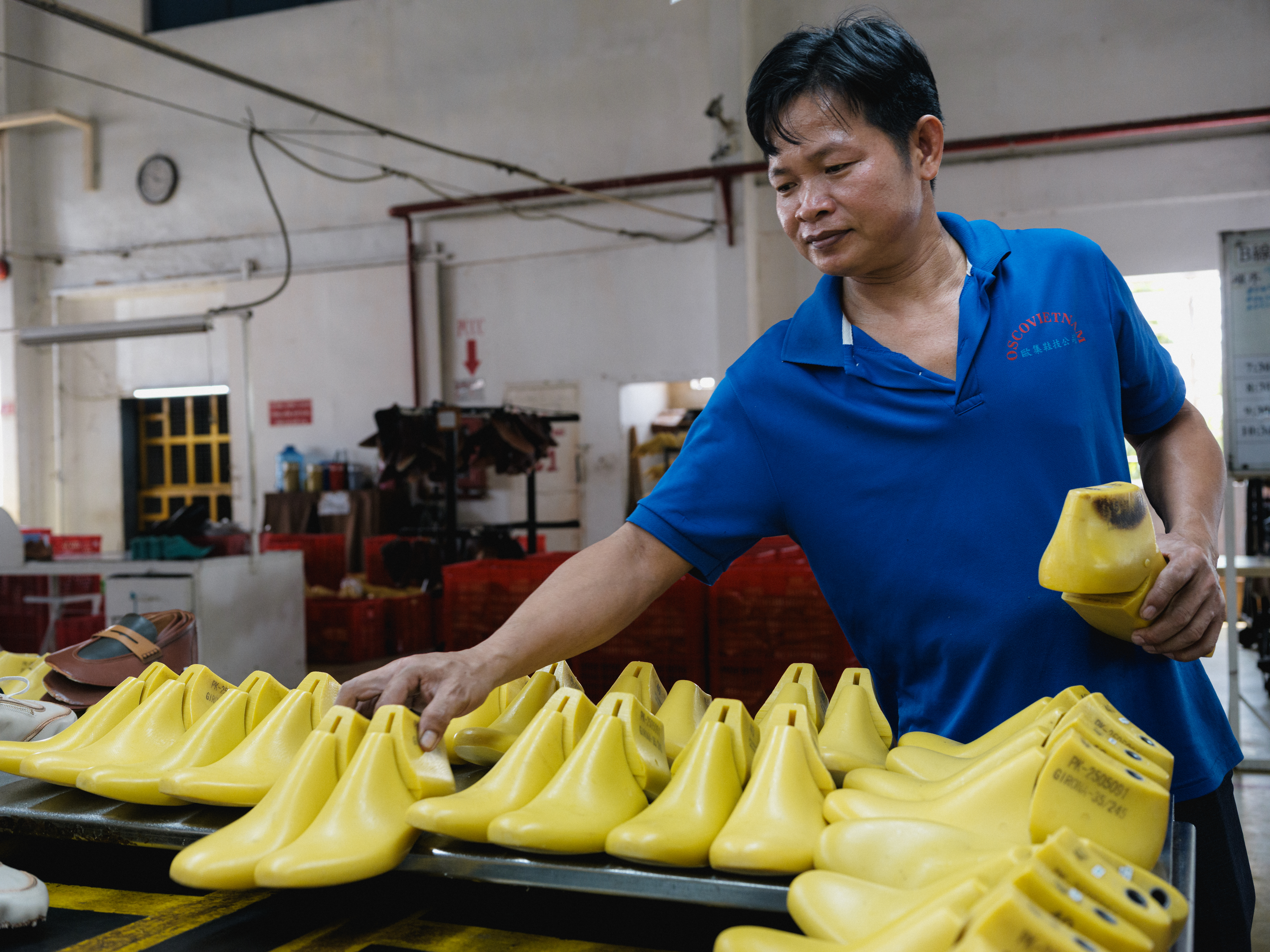 Worker in blue PPE at production machinery